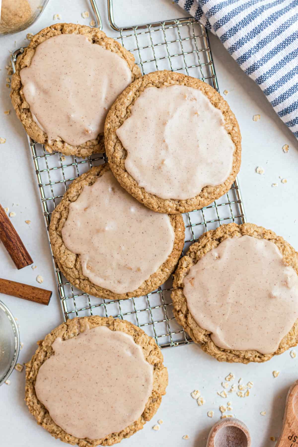 Iced oatmeal cookies arranged on a small wire rack.