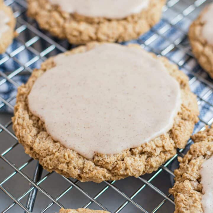 Cinnamon iced oatmeal cookie on a wire rack to cool.