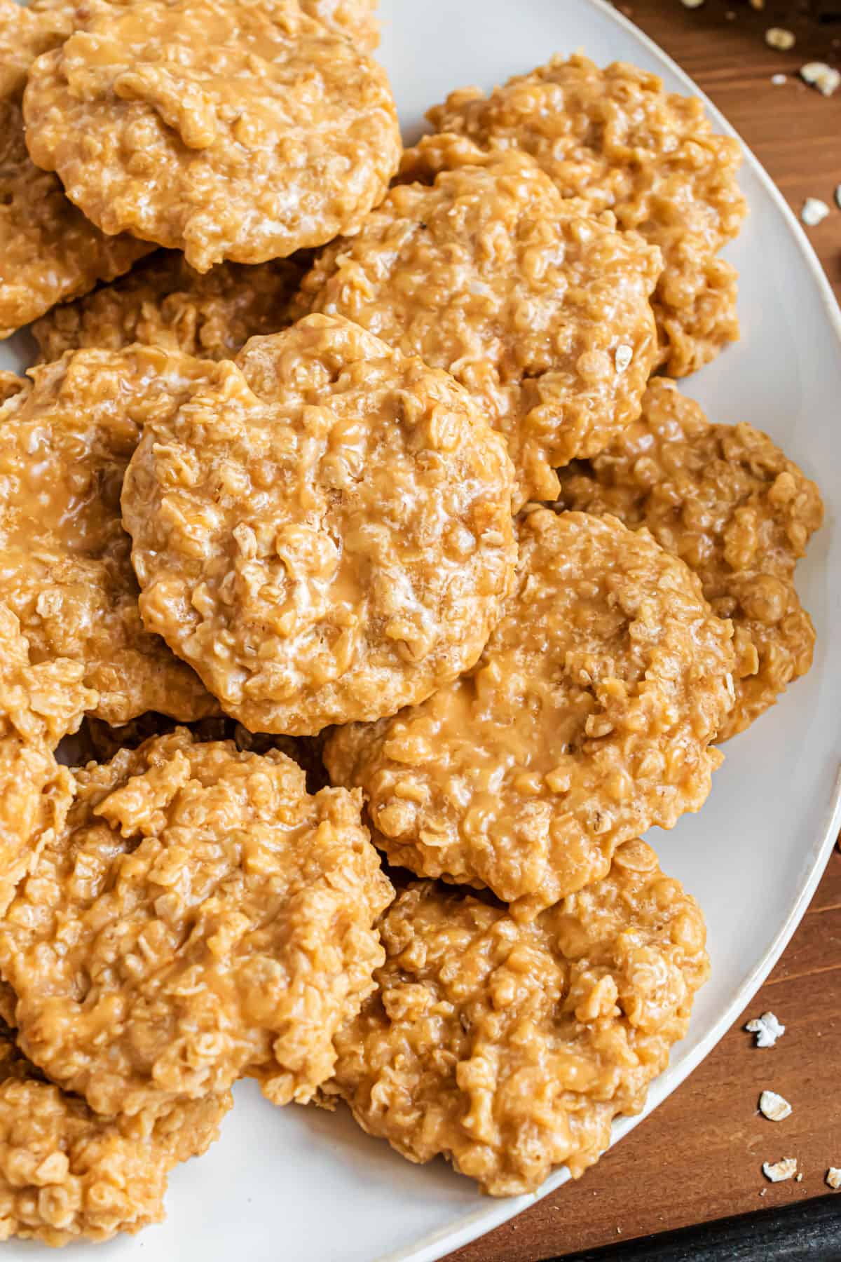 No bake oatmeal scotchies stacked on a white serving plate.