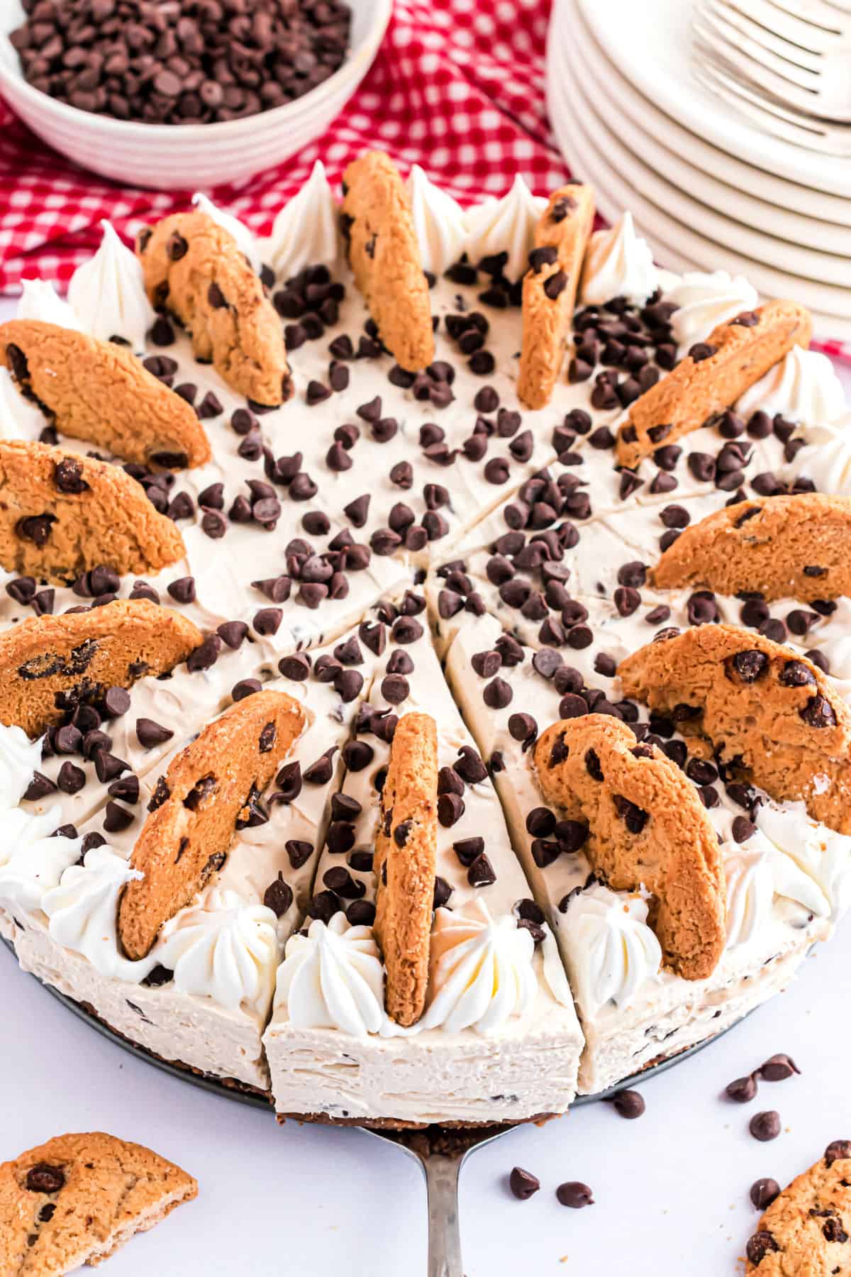 Creamy cheesecake topped with chocolate chipi cookies, chocolate chips, and whipped cream.