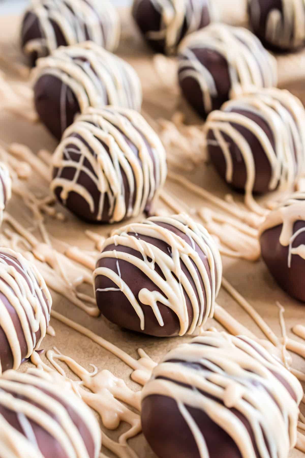 Chocolate truffles drizzled with white chocolate peanut butter.