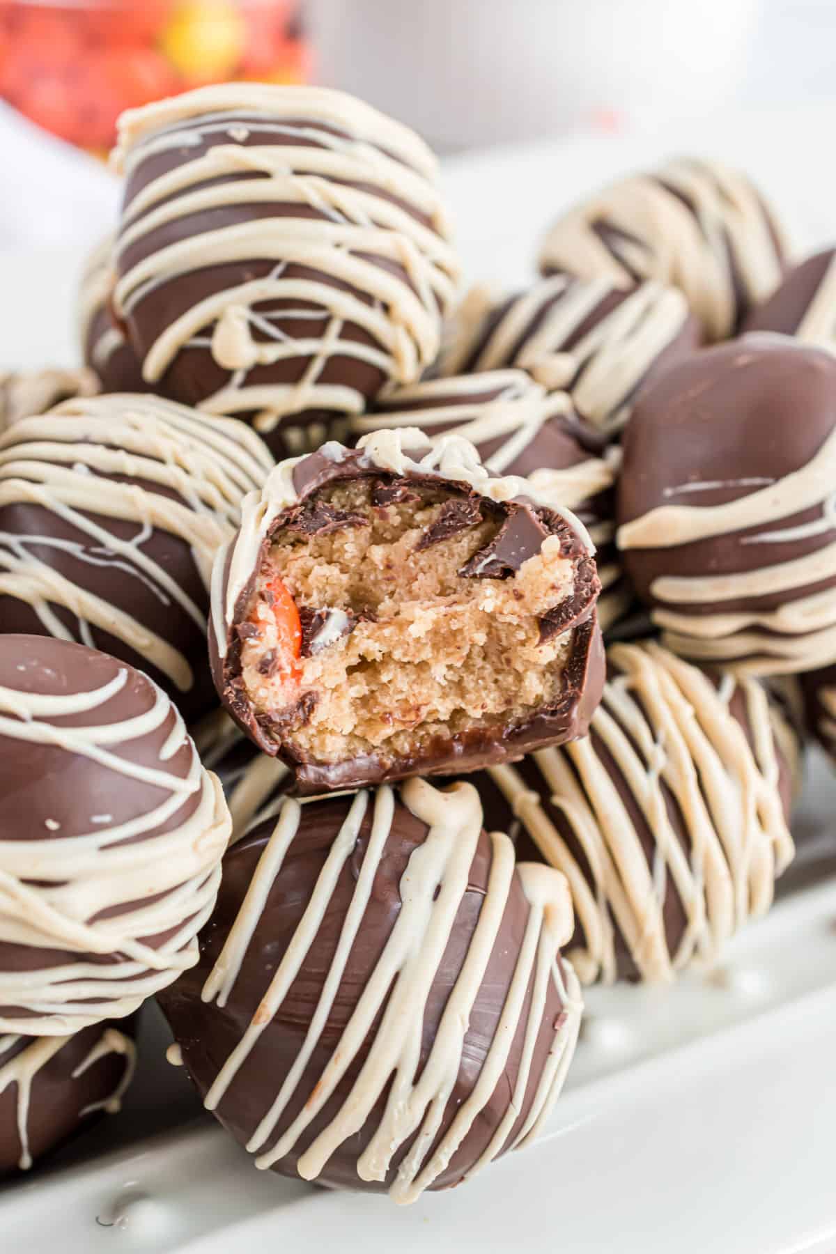 Stack of chocolate coated peanut butter cookie dough balls.