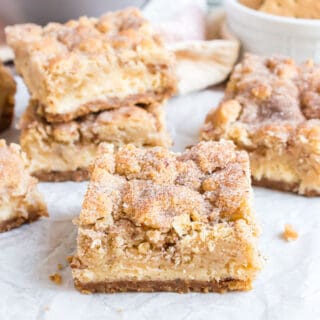 Snickerdoodle Cheesecake Bars are like cookies and cheesecake in one! A homemade graham cracker crust is topped with a creamy cheesecake layer and snickerdoodle cookie dough in this sweet and salty recipe.