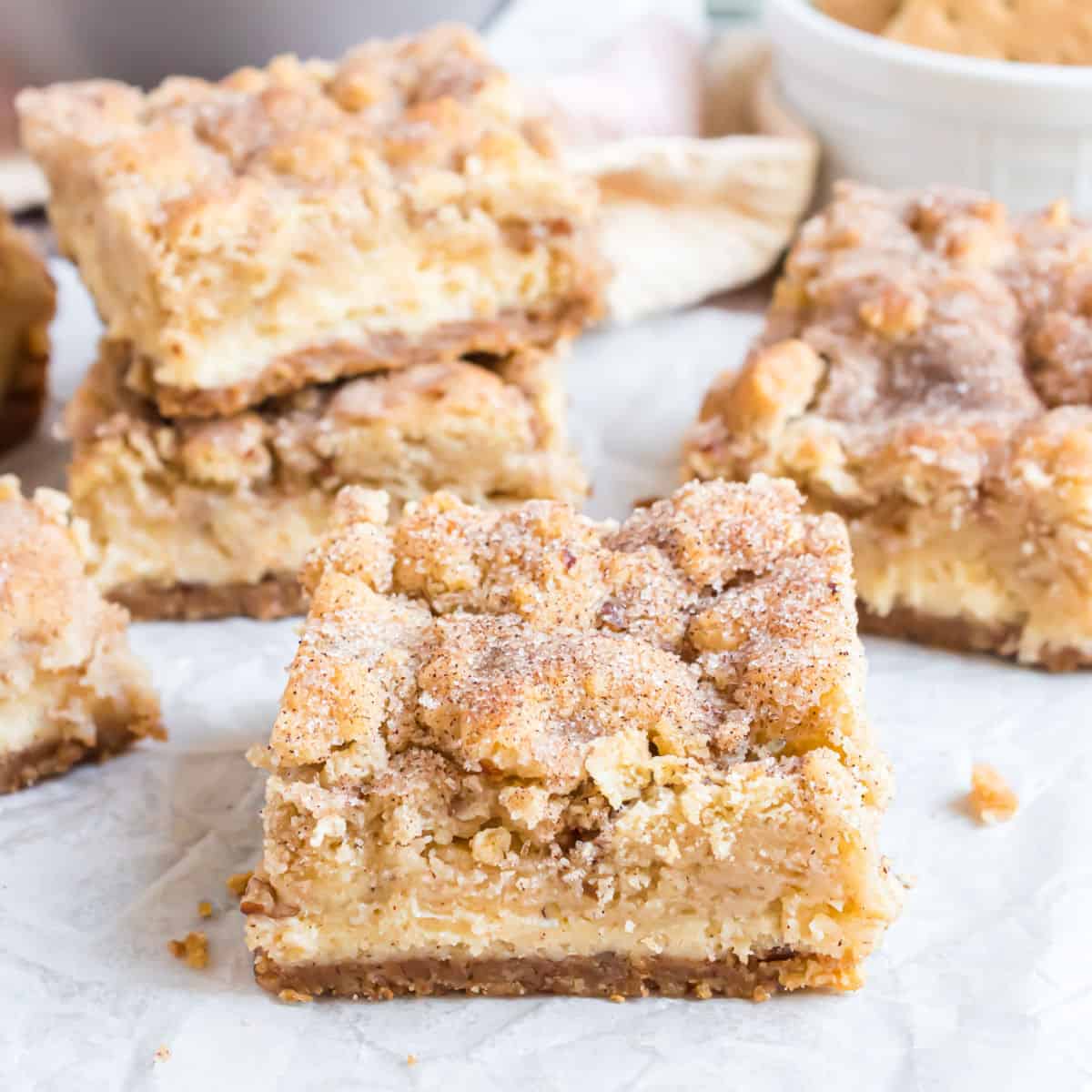 Snickerdoodle Cheesecake Bars are like cookies and cheesecake in one! A homemade graham cracker crust is topped with a creamy cheesecake layer and snickerdoodle cookie dough in this sweet and salty recipe.