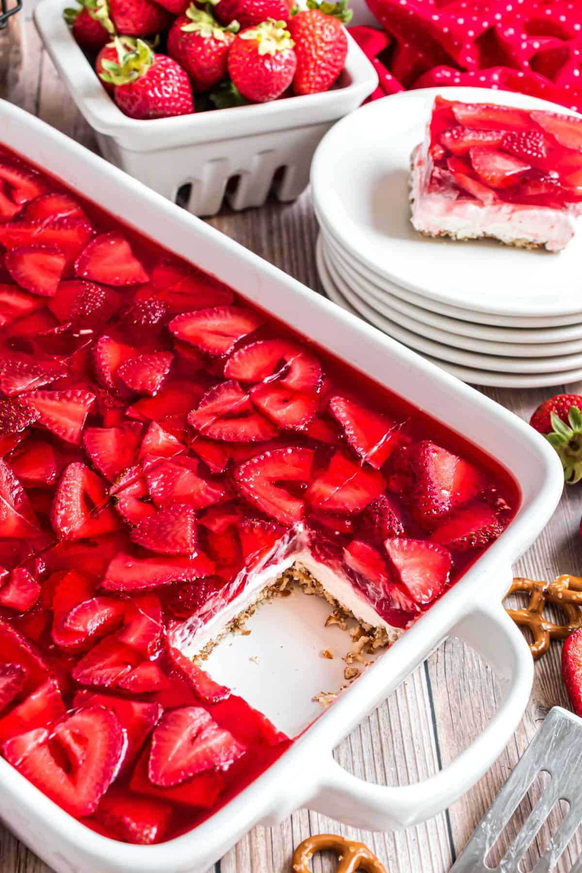 Strawberry pretzel jello in a white 13x9 dish.