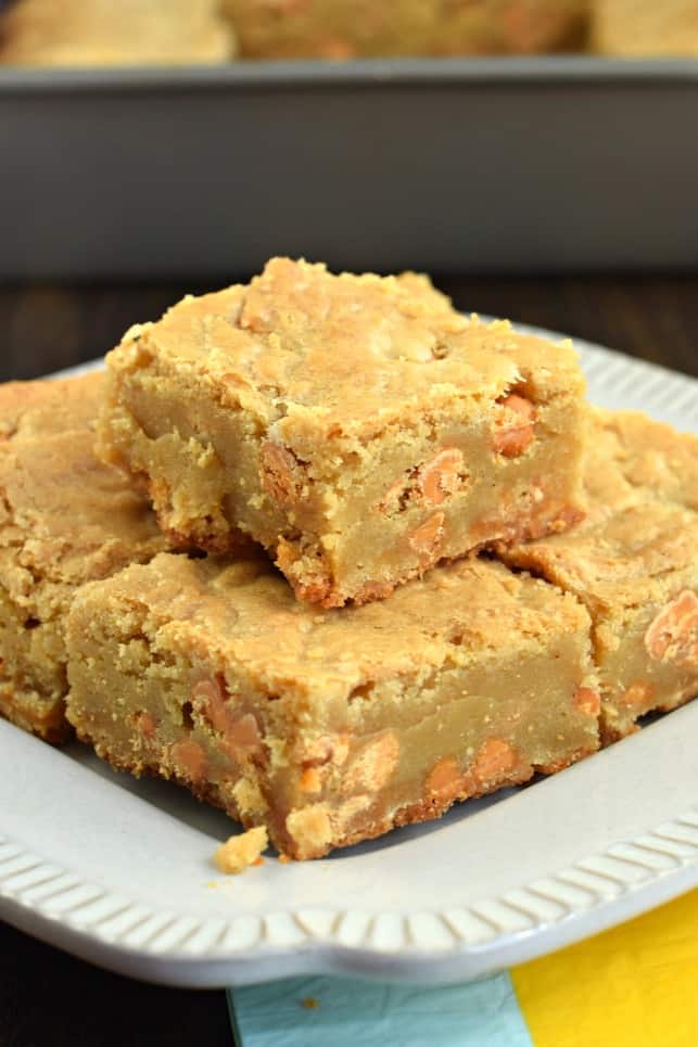 Butterscotch Blondies cut into large squares on a white plate.