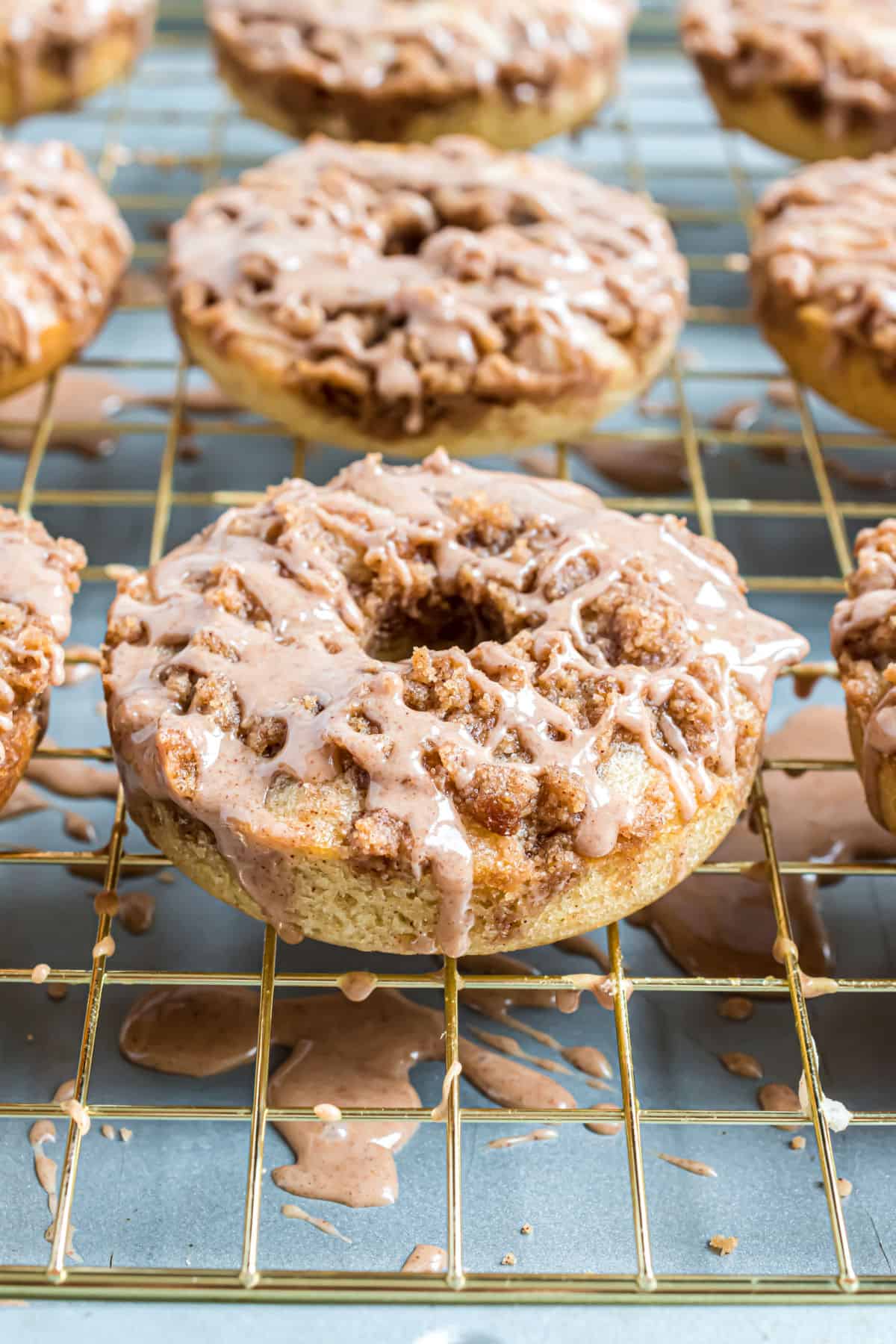 Coffee cake donuts on a wire rack.