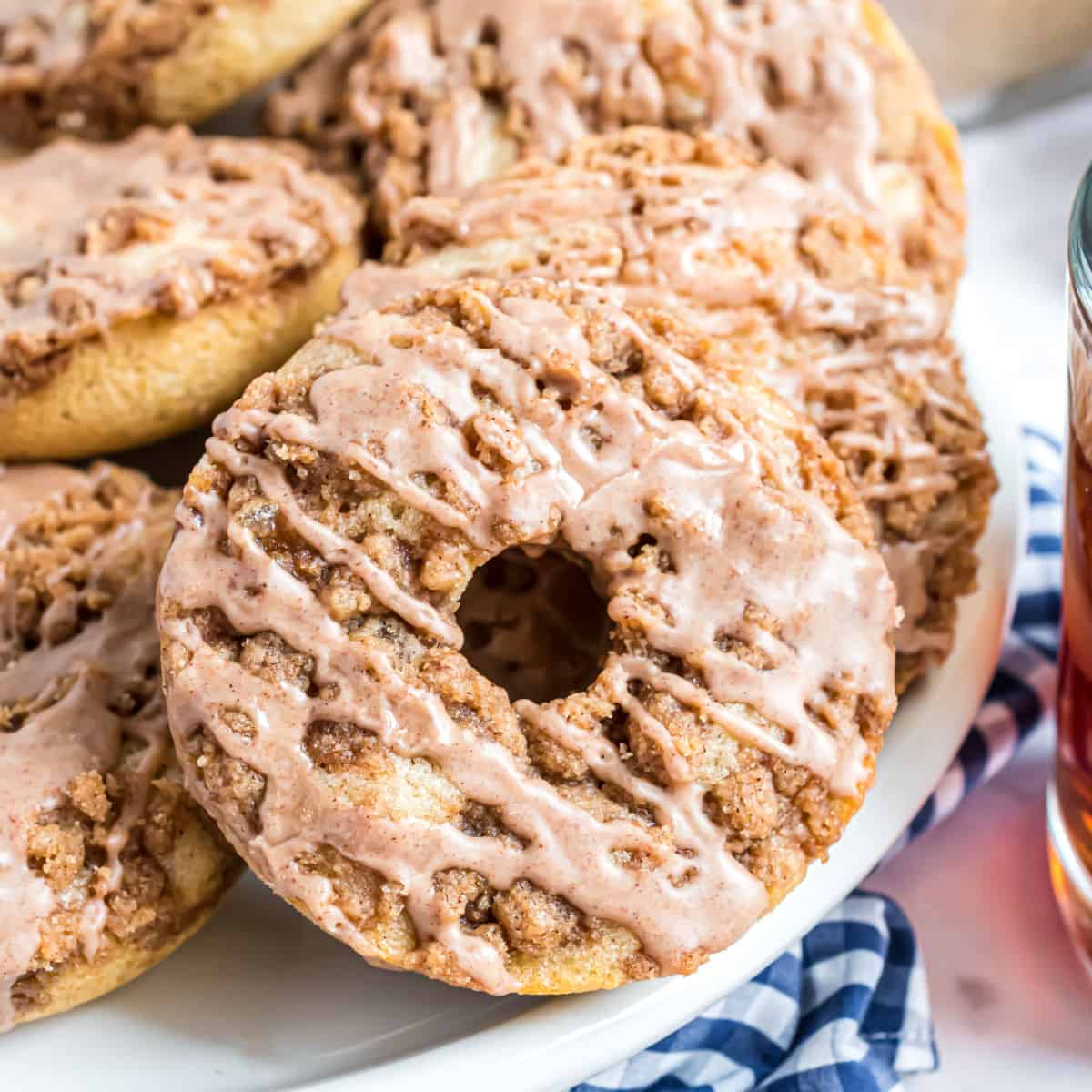 Tender, moist Cinnamon Coffee Cake Donuts with a chunky cinnamon streusel and sweet cinnamon glaze. This baked cinnamon donut recipe is perfect for a weekend or weekday breakfast!