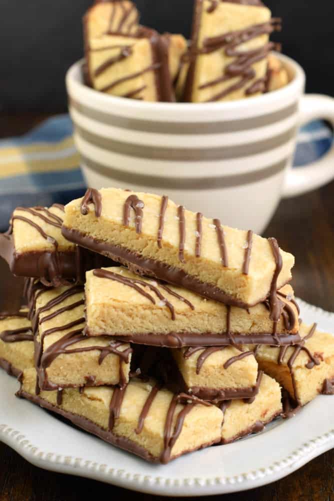 Buttery and delicious, these Dark Chocolate Peanut Butter Shortbread Cookies are the perfect dessert. Add a sprinkle of sea salt and your taste buds will thank you! #cookies #peanutbutter #shortbread Peanut butter shortbread cookies with chocolate drizzle.