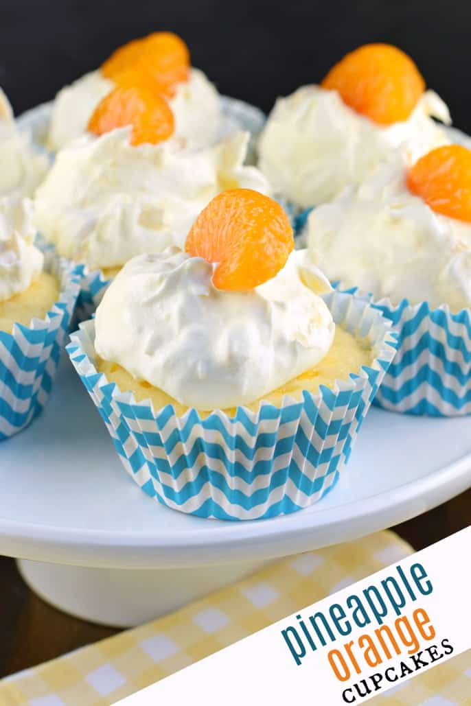 Pineapple cupcakes with cool whip and mandarin oranges on top.