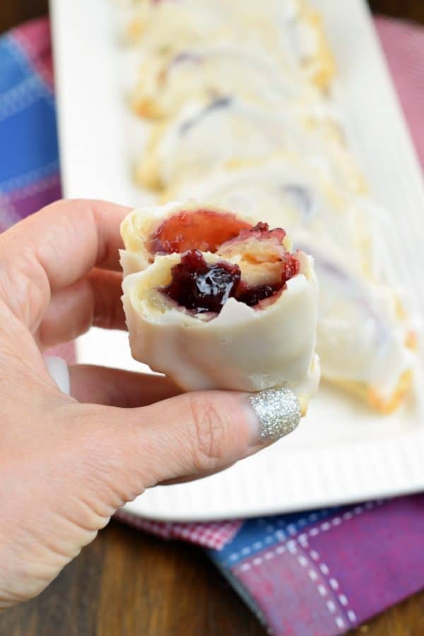Combining strawberry and blueberry pie filling results in the most delicious, baked Berry Hand Pies. Perfect for summer, holidays, or anything in between! #handpies #summer #berries #berrypie #pie #baking