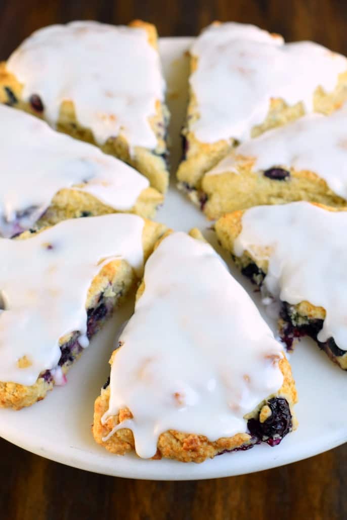 Blueberry scones on a white serving plate.