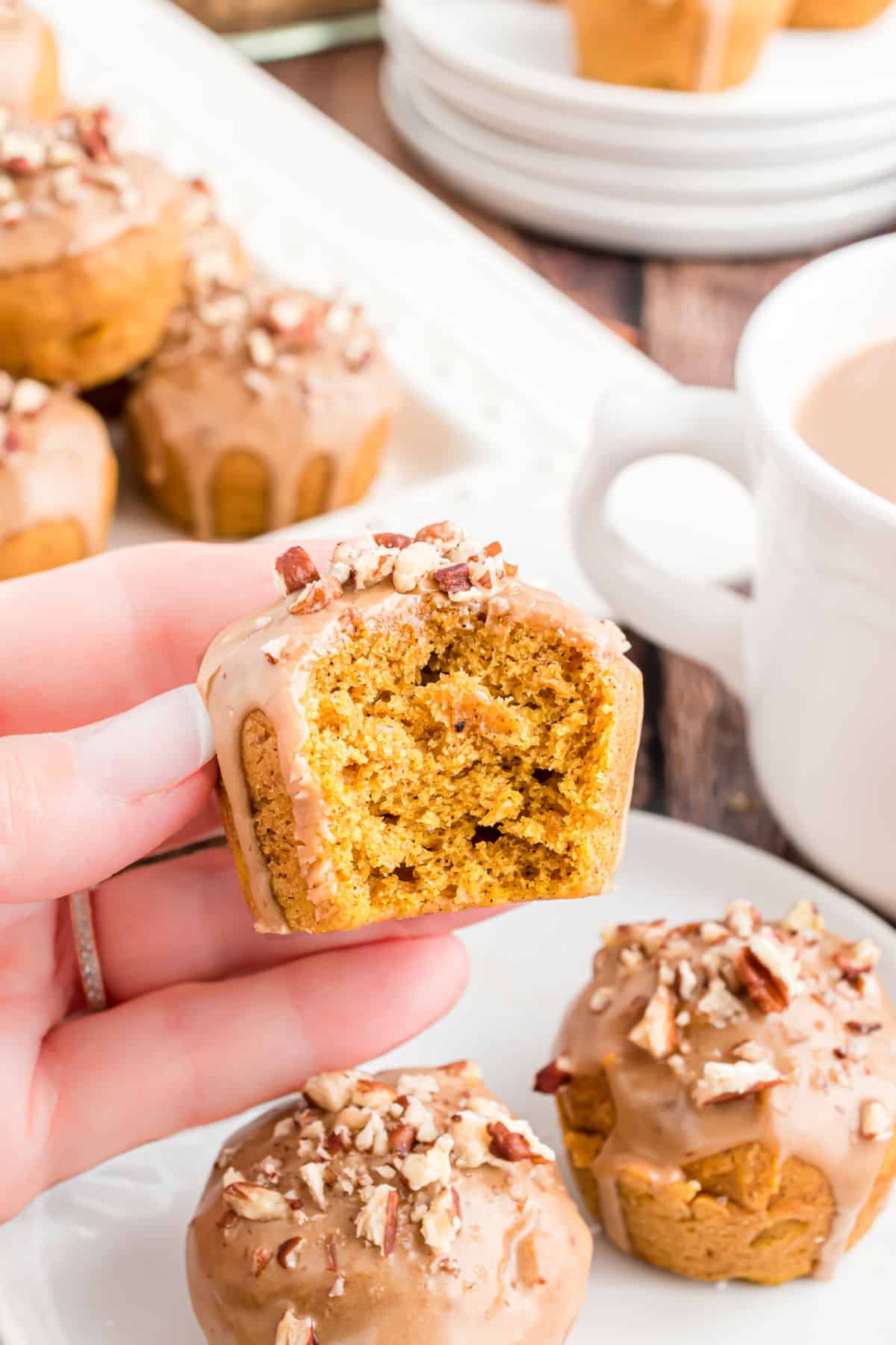 Mini pumpkin muffin with a bite taken out.