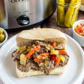 Looking for a delicious weeknight dinner idea? This Slow Cooker Italian Beef has very little prep work involved. Add everything to the slow cooker and come home to a hearty flavorful meal.