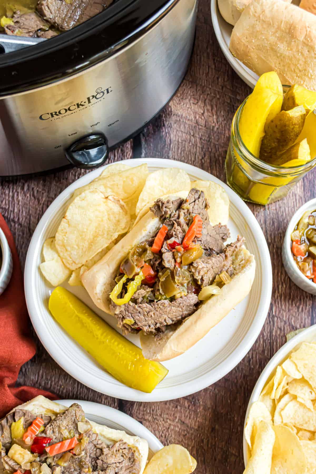 Italian beef sandwich on a plate with potato chips.