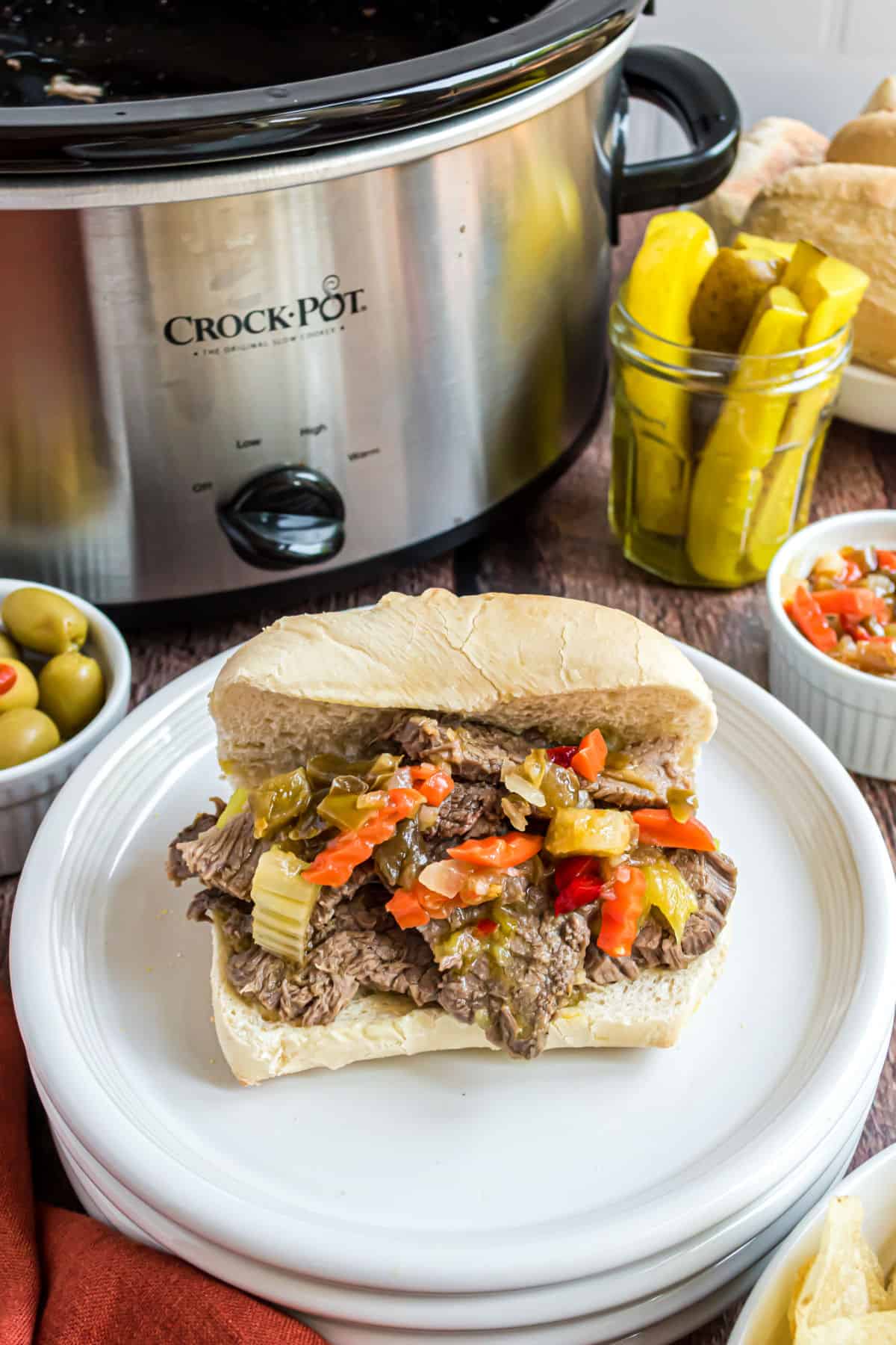 Italian beef sandwish with giardiniera on top.