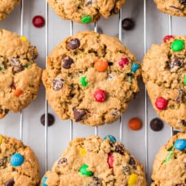 Monster cookies on silver cooling rack.