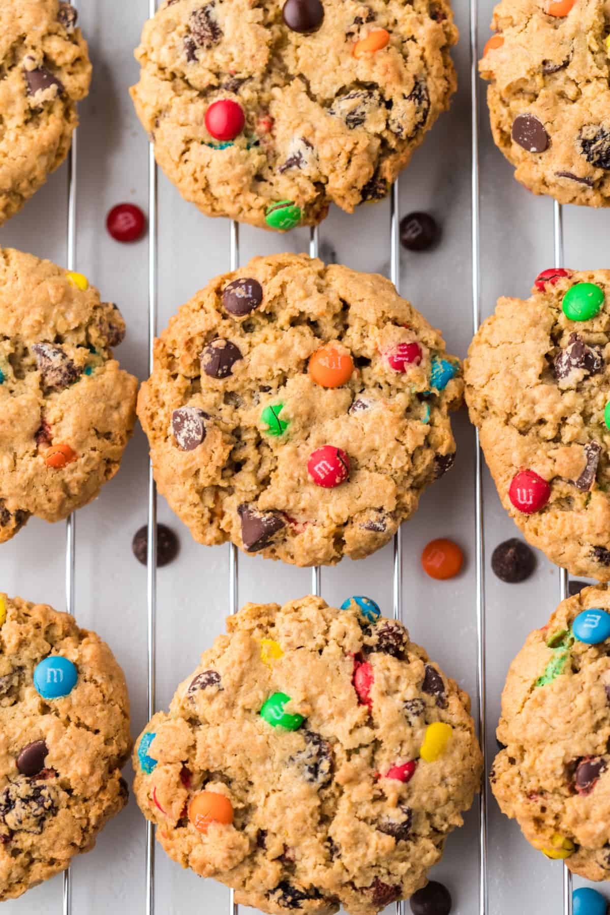 Monster cookies on silver cooling rack.