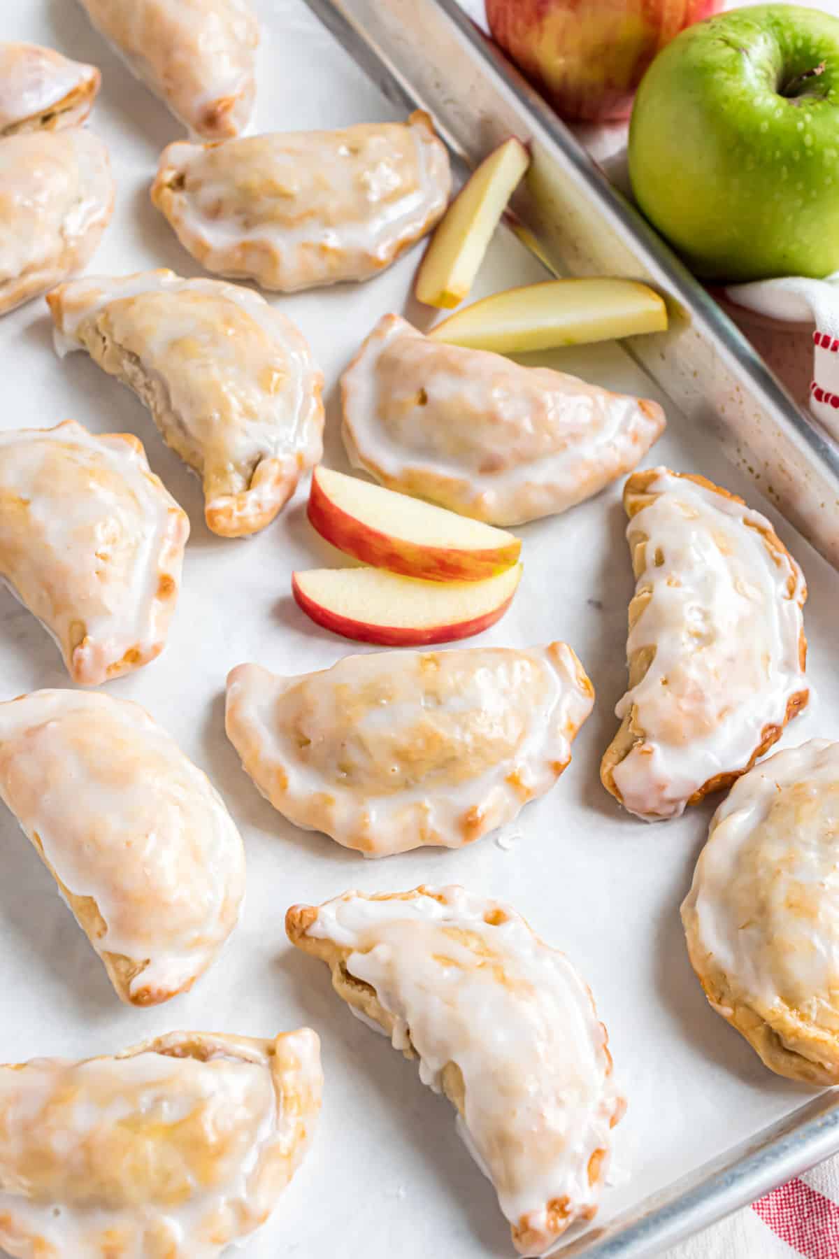 Apple hand pies on a cookie sheet.