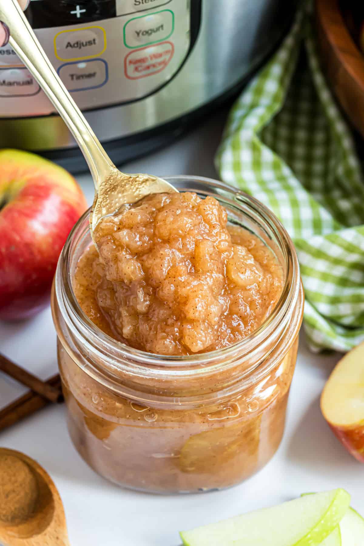 Applesauce in a mason jar with a spoon to serve.