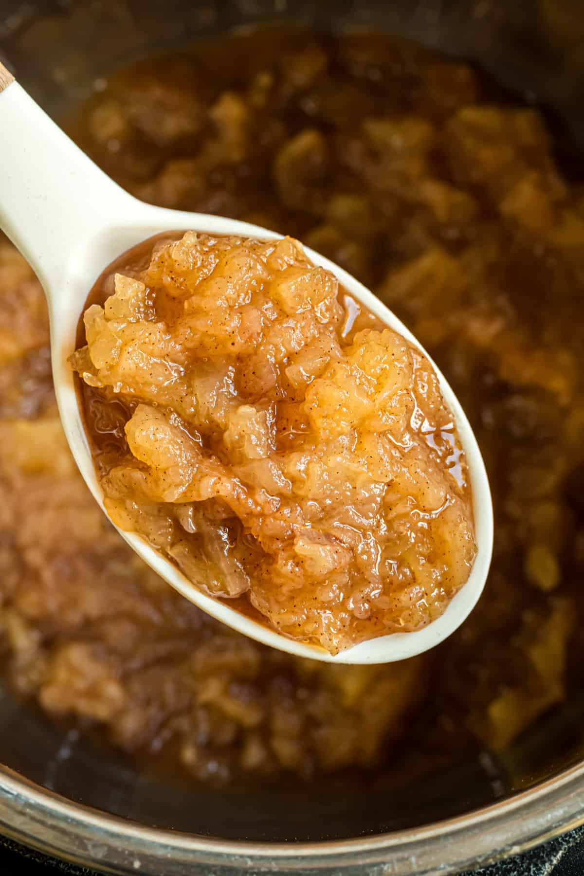 Applesauce on a white spoon.