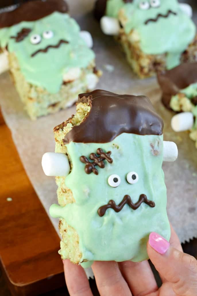 Mint chocolate chip Frankenstein rice krispie treat with one bite removed.