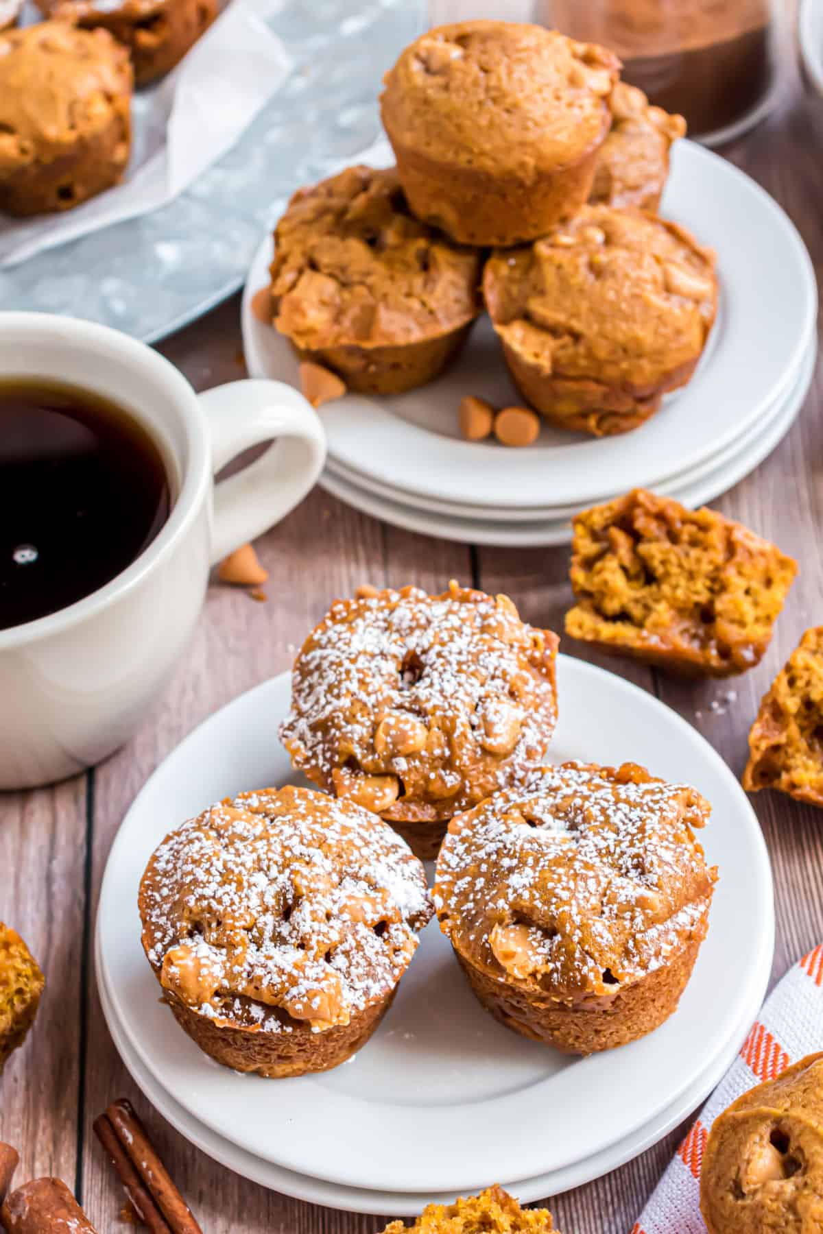 Mini pumpkin muffins served on white plates with coffee.