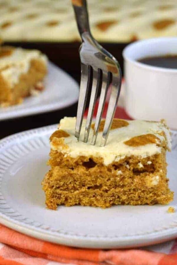 The easiest, most perfect PUMPKIN Cheesecake Bars recipe! Super moist pumpkin cake topped with swirls of cheesecake #fallbaking #pumpkin #thanksgiving #cheesecake