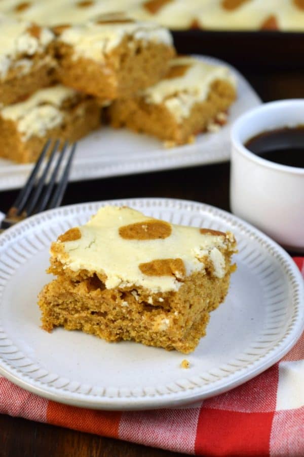 Tender, moist pumpkin cake topped with cheesecake. These Pumpkin Cheesecake Bars are the perfect fall dessert.
