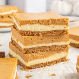 The best Pumpkin Cheesecake Bars recipe is here, packed with flavor and easy to make! Layered with a graham cracker crust, cheesecake filling, pumpkin filling, and topped with fresh whipped cream, this is a dreamy dessert!