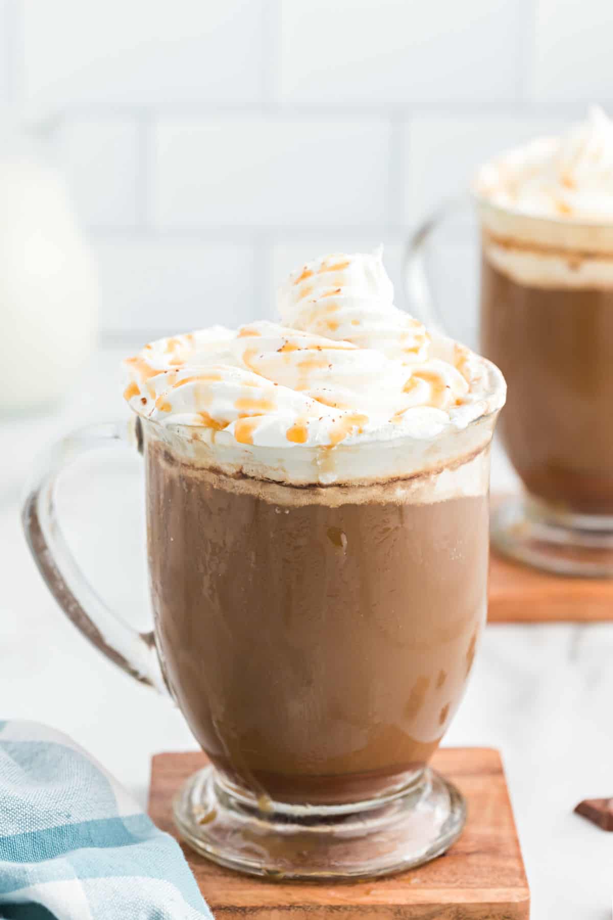 Caramel mocha in a clear glass mug with whipped cream.