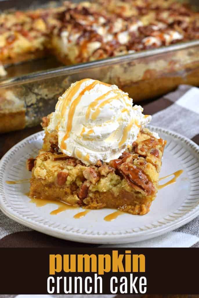 Pumpkin dump cake with vanilla ice cream on white plate.