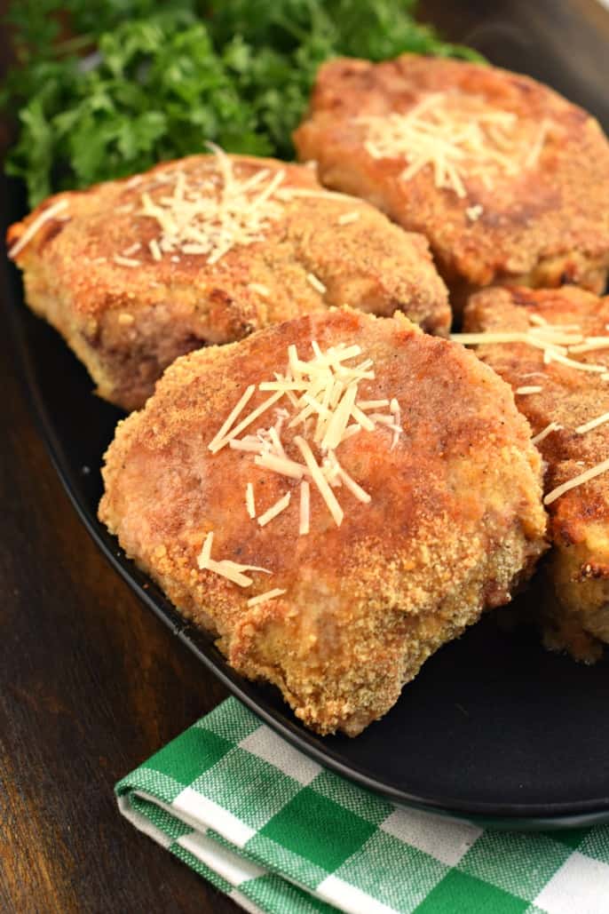 Parmesan crusted pork chops on serving tray.