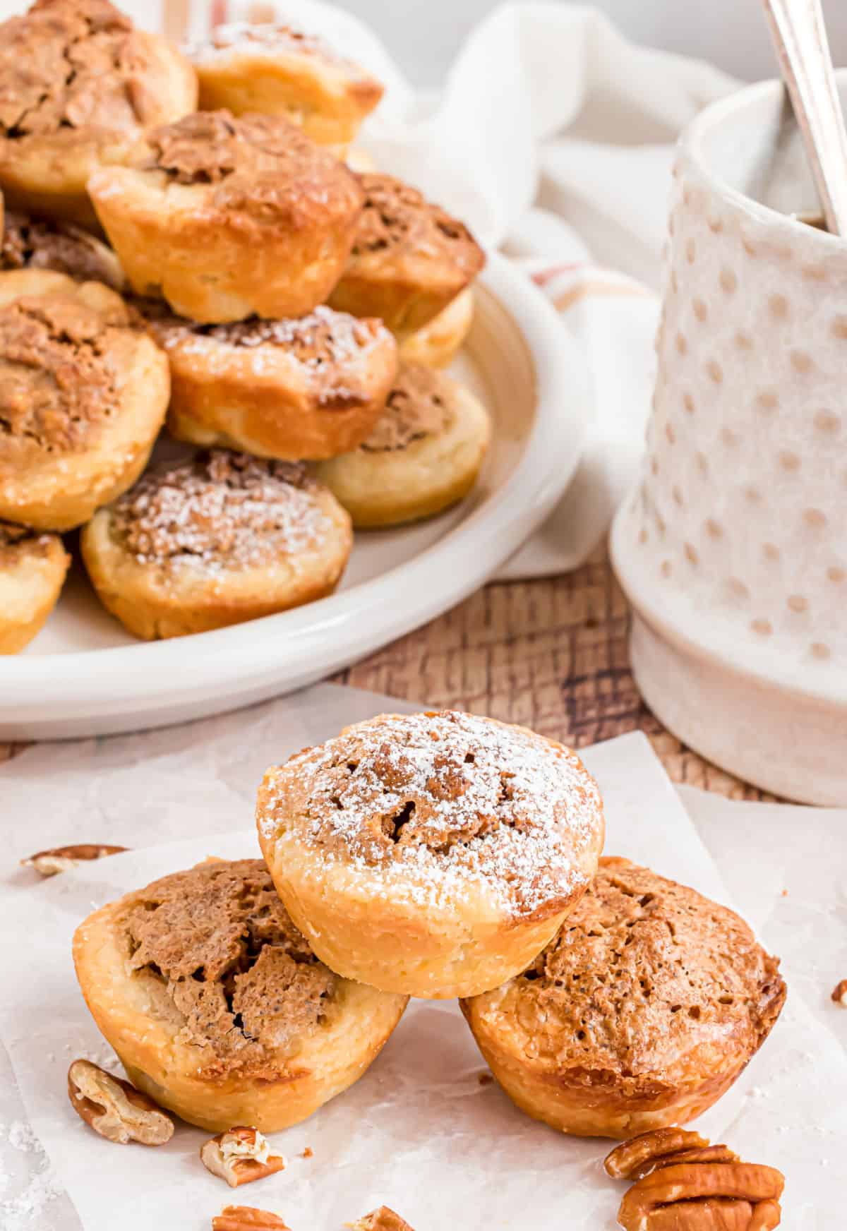 Pecan tassie cookies stacked on top of each other.