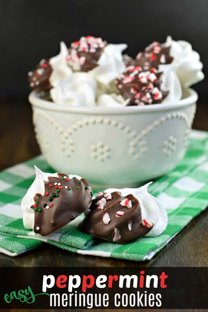 Melt in your mouth, Peppermint Meringue Cookies, just in time for the holidays. You'll want to add a handful of these sweet cookies to all your holiday plates! Bowl of white meringue cookies dipped in chocolate and crushed candy canes.