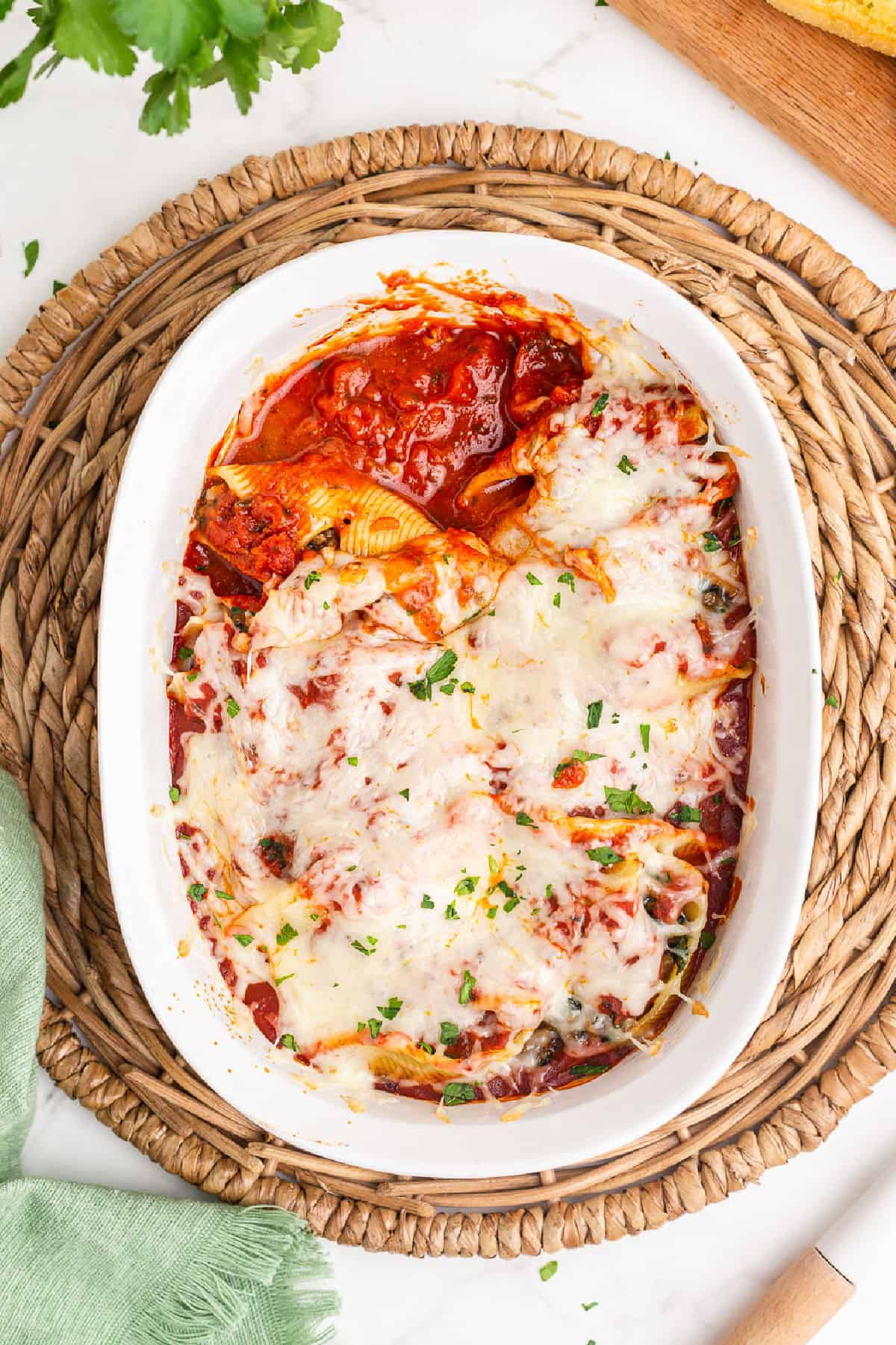 Sausage stuffed shells in casserole dish with melted cheese.