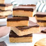 Buckeye bars stacked on a piece of parchment paper.