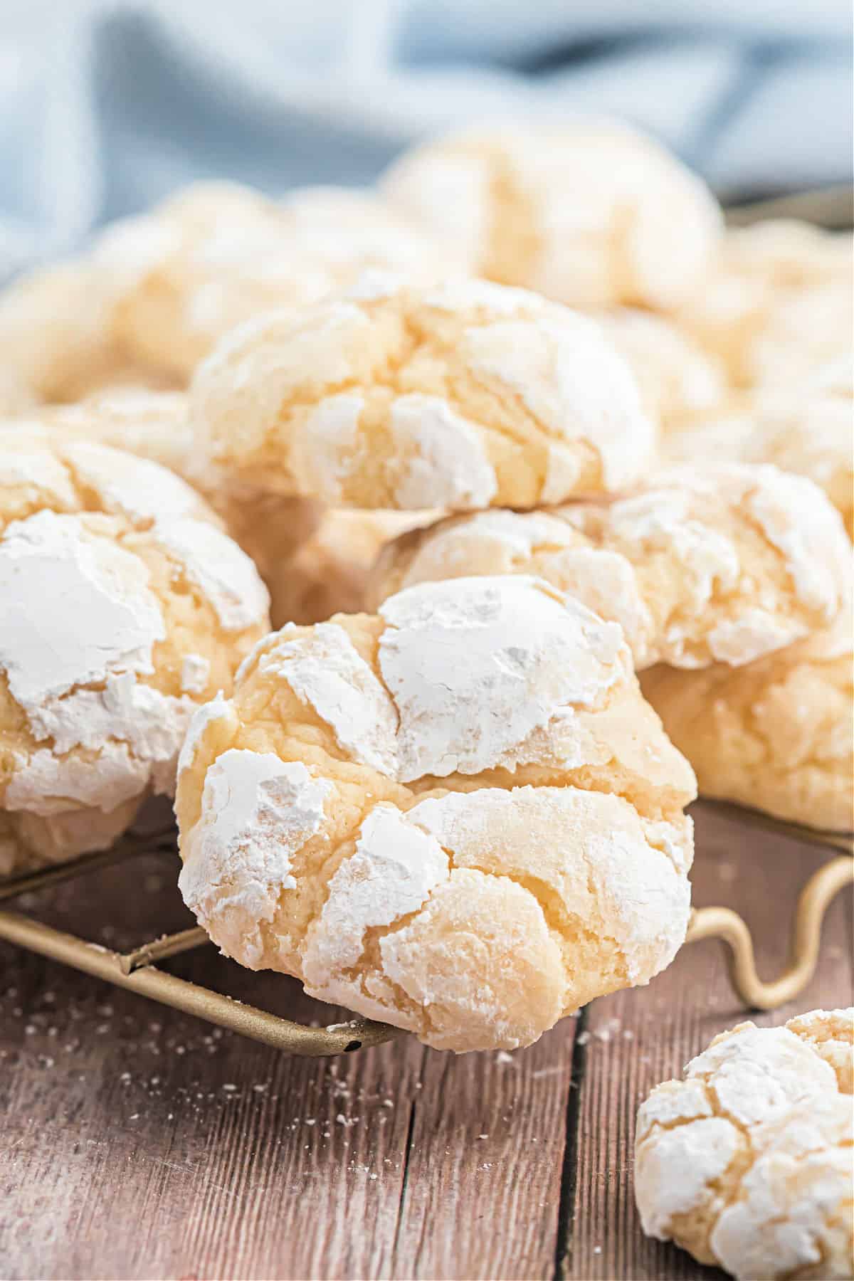 Butter cookie with powdered sugar on a wire cooling rack.