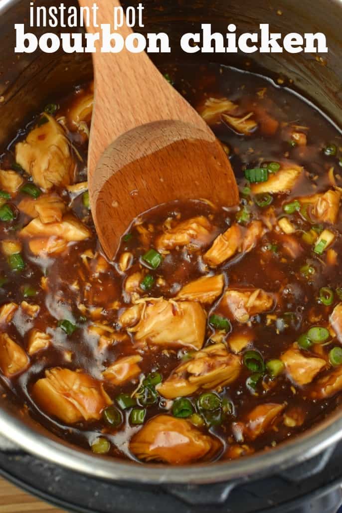 Bourbon chicken in an instant pot with a wooden spoon.