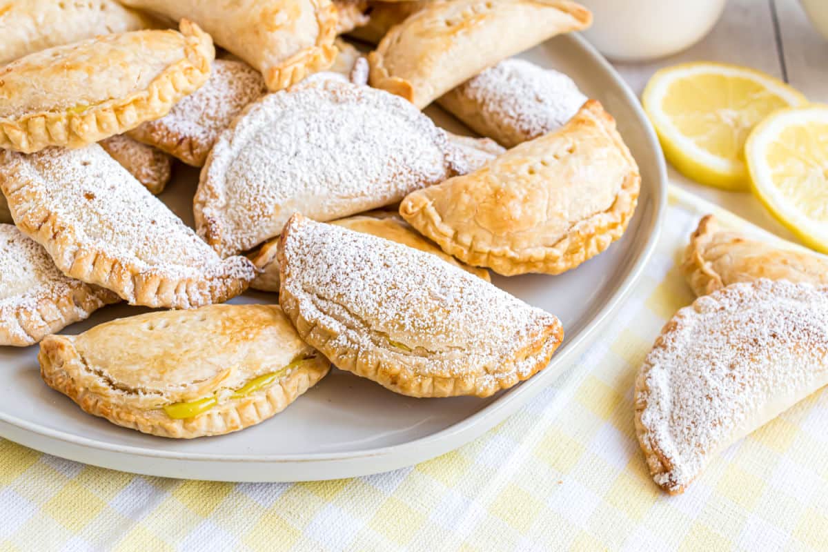 Hand pies on a white serving plate.