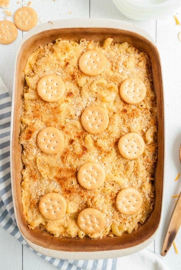 A 13x9 baking dish with baked mac and cheese topped with crackers.