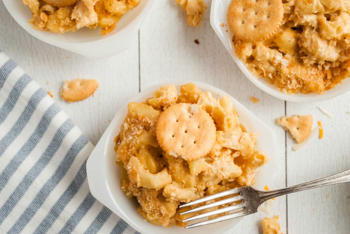 Creamy homemade mac and cheese in a white serving dish with a fork.