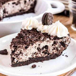Slice of oreo cheesecake on a white plate.