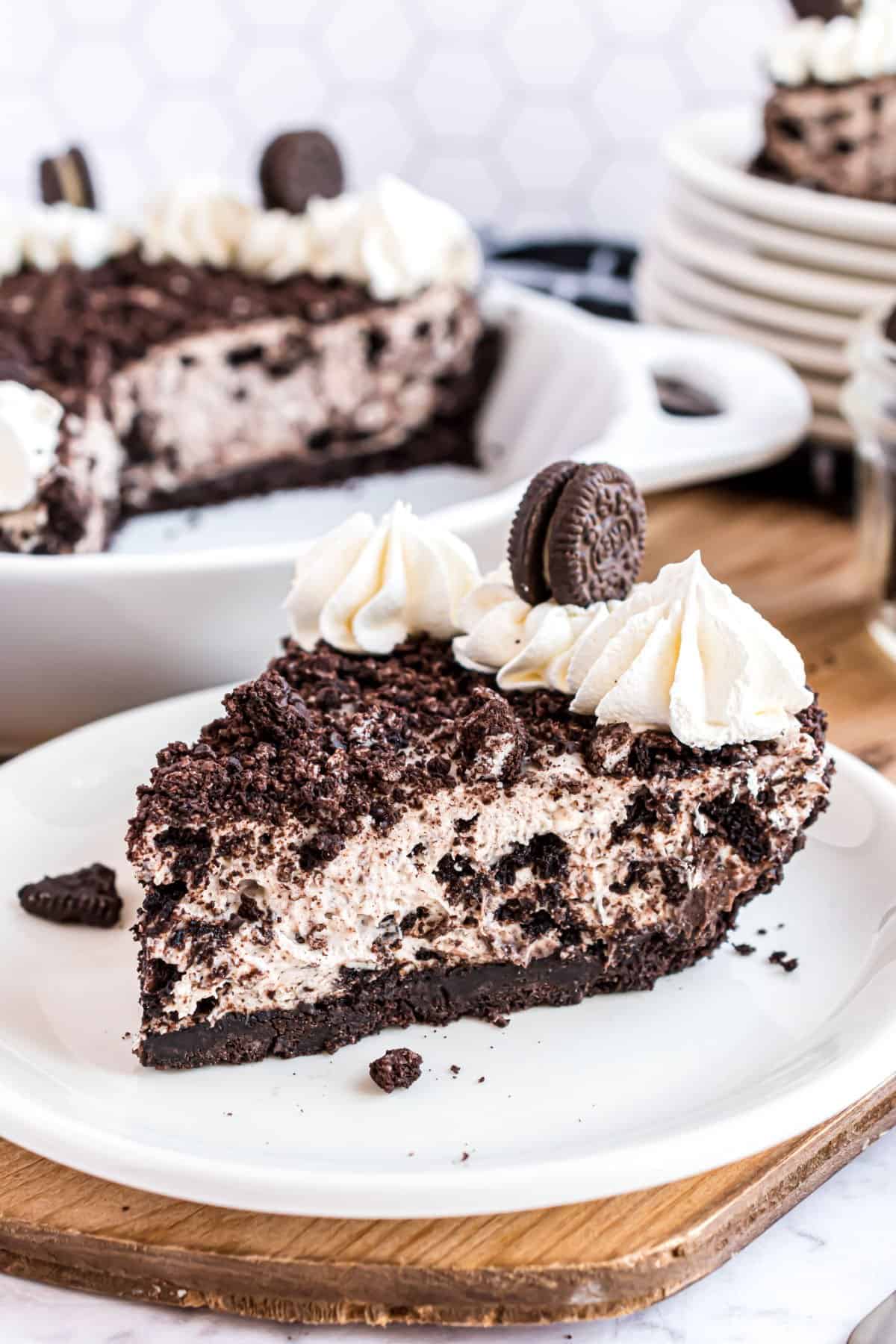 Oreo cheesecake slice on a white plate.