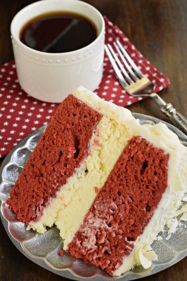 The BEST Red Velvet Cheesecake Cake recipe starts with two layers of homemade red velvet cake with a layer of cheesecake in the middle. Topped with delicious cream cheese frosting