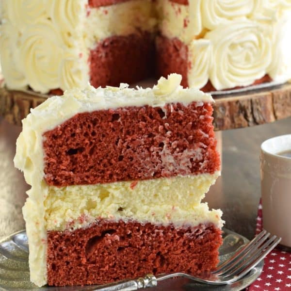 The BEST Red Velvet Cheesecake Cake recipe starts with two layers of homemade red velvet cake with a layer of cheesecake in the middle. Topped with delicious cream cheese frosting