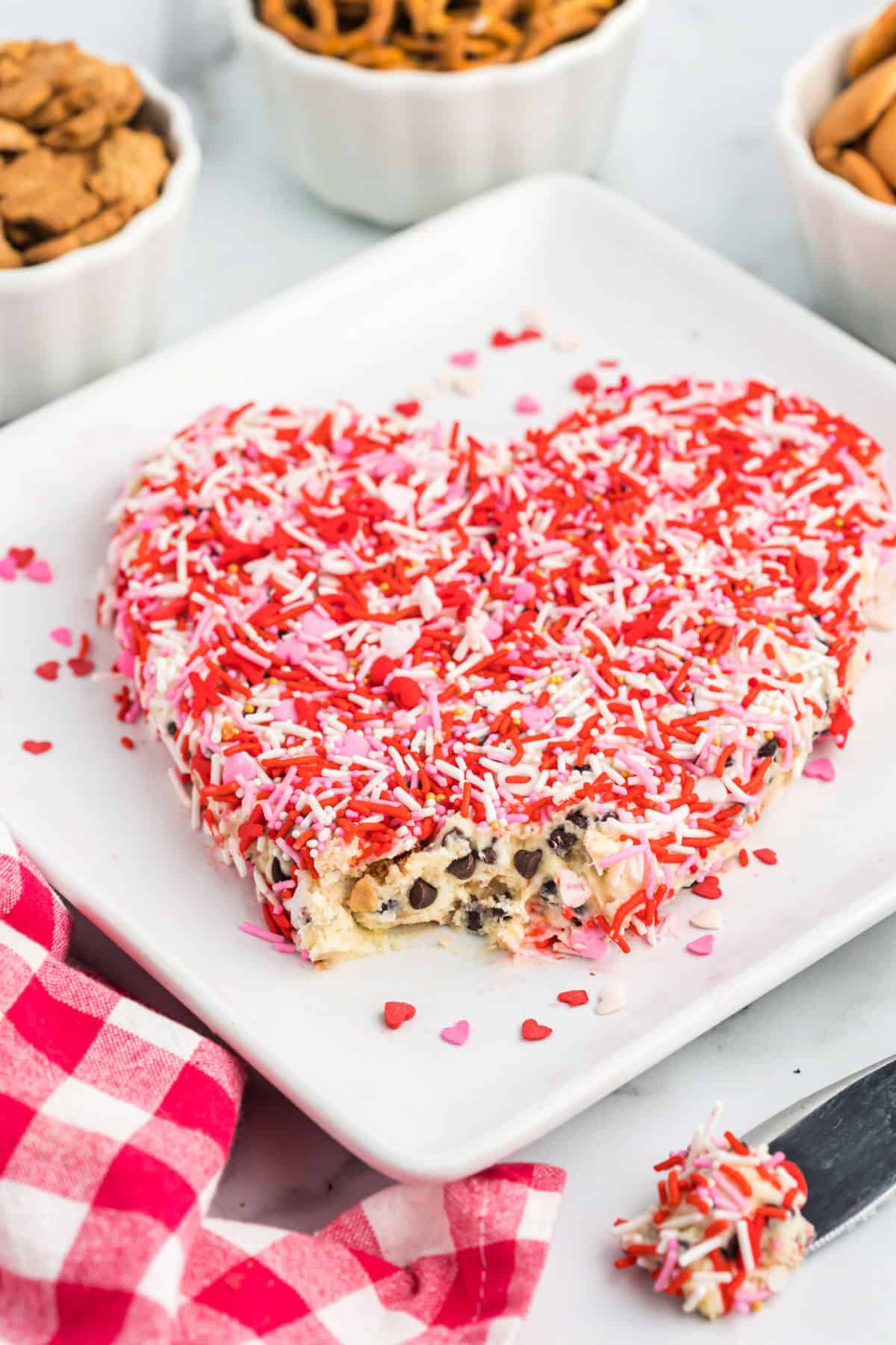 Sweet cheeseball topped with red and pink sprinkles.