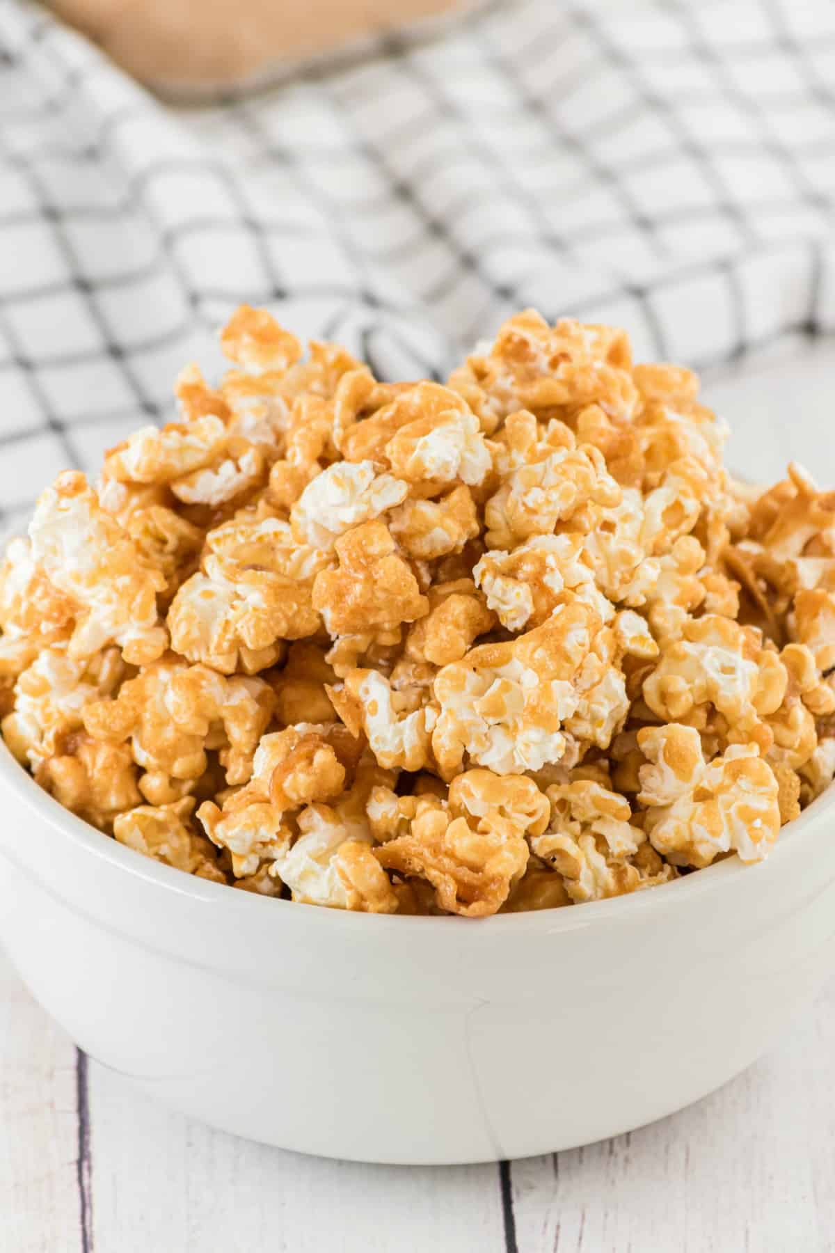 Caramel corn in a white bowl.