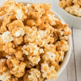 Caramel corn in a white bowl for serving.
