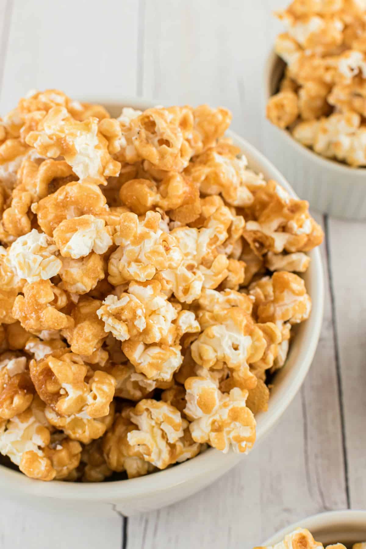 Caramel corn in a white bowl for serving.